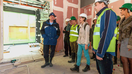 Students visiting a new, more energy efficient building